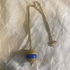 Solid perfume necklace. Cannot find a name on it.